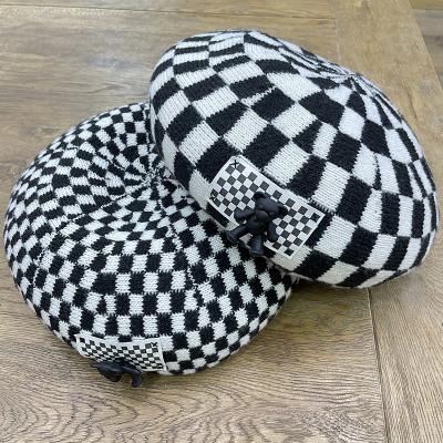 China Fashion\comfortable black and white hat\goods 2021 new beret pattern plaid design for women knitted winter hat with bear shape decoration for sale