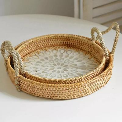 China Oval Rattan Serving Tray Storage Basket Round Rattan Tray Indonesia Rattan Baskets Bed Tray Mushroom Basket for sale