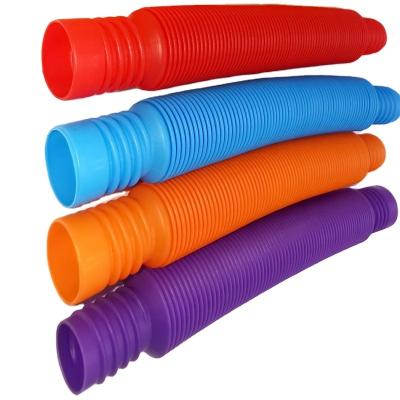 China PP mini relaxation pop music tube to develop practical capacity tubefinger telescopic plastic toys whistle for sale