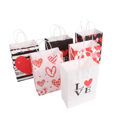 China 2022 Hot Selling Recyclable Heart Design Gift Bag Kraft Paper Customized Gift Bag With Paper Handle Direct From Factory for sale