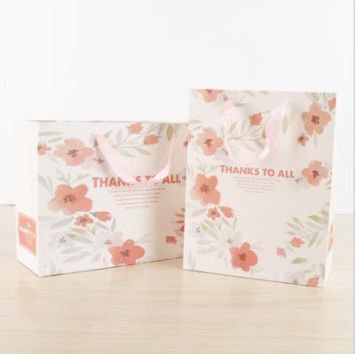 China Recyclable Unique Design Paper Bag Cardboard Custom Flower Printing Various Gift Bag Sizes Direct Selling Cheap Price With Ribbon Handle for sale