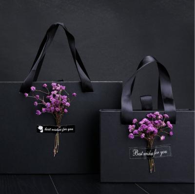 China 2022 New Design Whole Sale Recyclable Customized Gift Packaging Paper Bag Customized Gift Wrapping Paper Bag With Dry Flower And Ribbon Handle Bottom Price for sale