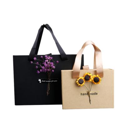 China Best Selling Design Paper Party Favor Bag Recyclable Customized Paper Bag Whole Party Gift Bag With Ribbon Handle With Dry Flower for sale