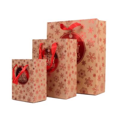 China Customized Luxury Recyclable Red Hot Stamping Christmas Design Paper Bag Art Paper Gift Bag Gift Bag With Ribbon Handle for sale