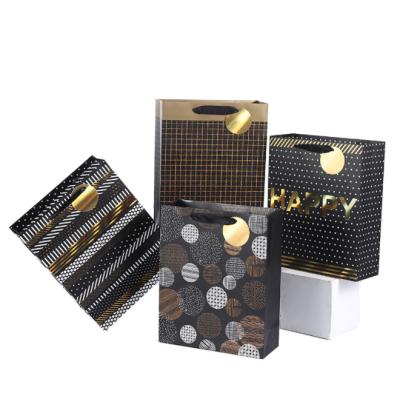 China Hot Stamping Christmas Geometry Design Recyclable Fashion Customized Gift Bag Gold Gift Bag With Ribbon Handle for sale