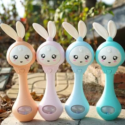 China Musical Wholesale 4 Colors Rabbit Rattle Glowing Musical Hand Baby Rattle Toy with Teether for sale