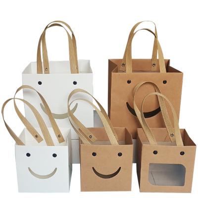 China Handmade Creative Smile Face Gift Bag Kraft Paper Bag With Window Custom Packing Bags for sale