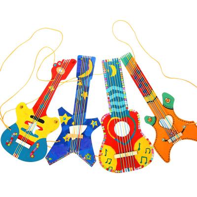 China Eco-friendly Wooden Material White Musical Instrument Homemade Guitar Kindergarten Guitar Graffiti Painting Creative DIY Material Package for sale