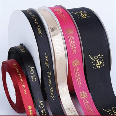 China Custom Recyled Logo Gold Foil Printed Brand Name Satin Ribbon for sale