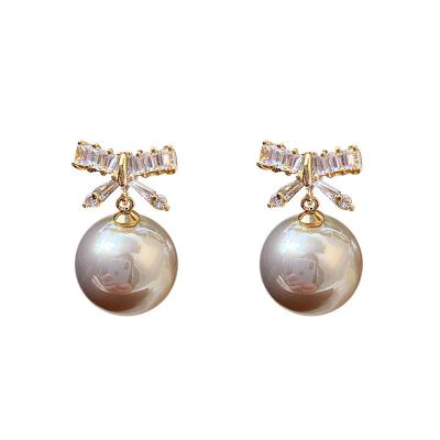 China Personality Lead Free Nickel Free Korean Soft Silver Needle Temperament Pearl Bow Zircon Dangle Earrings for sale