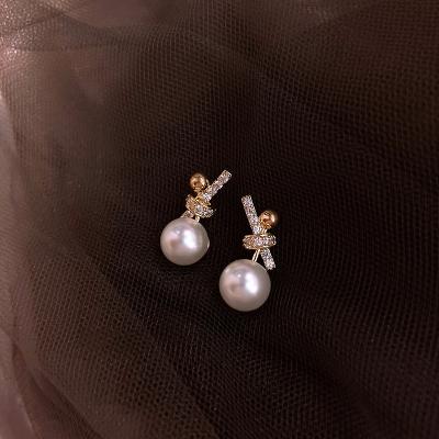 China Lead-free nickel-free bow knot pearl earring female contracted temperament small earnail tidal earphone pendant the new for sale