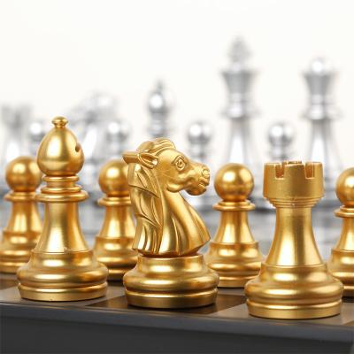 China Luxury Magnetic International Chess Board Puzzle Chess Set Portable Gold Board And Silver Color Chess Folding for sale