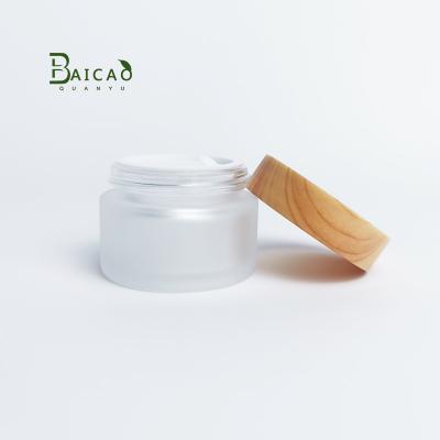 China Universal Packaging 30g Stain Face Cream Bottles Glass Bamboo Wooden Bottle With Bamboo Lid Frosted Glass Bottle for sale