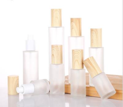 China Matte Household Products Bamboo Spray Bottle Bamboo Cosmetic Packaging Glass Bottles With Pumps for sale