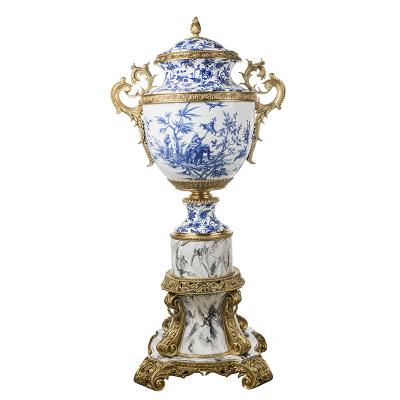 China Home Decor Stocked Luxury Blue and White Porcelain Fiqurines with Handle Brass Crafts Ceramic Storage Jar for sale