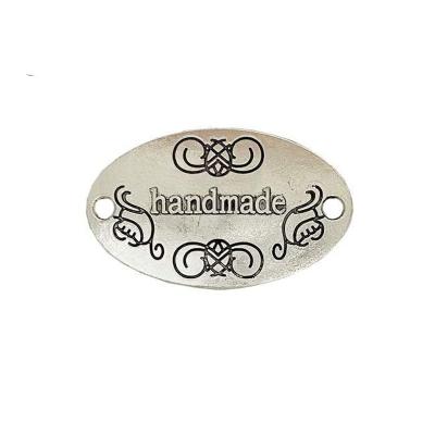 China Viable Handmade Metal Tags Alloy Pearl Charm Metal Label Tag Metal Pendant Handcrafted Logo For Bag Clothes for sale