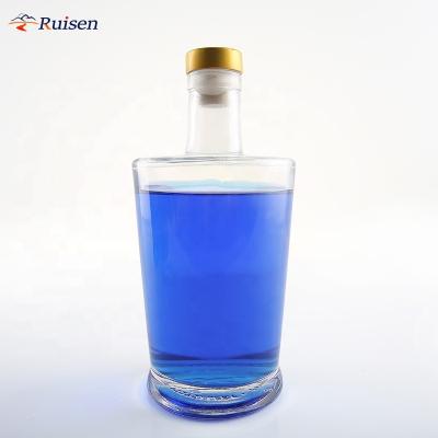 China Super Hot Sale Beverage Flint 500ml 750ml Round Shape Embossed Custom Logo Liquor Glass Bottle With Cork for sale