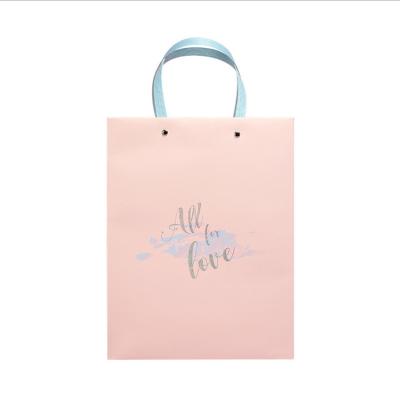 China Recycled Materials Factory Sale Low Price Guaranteed Quality Packaging Pink Bag Paper Bag Simple Elegant Gift Bag For Birthday Scarf Clothing for sale