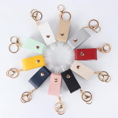 China Decoration for Bag and Keys Squeeze Portable Hand Sanitizer Bottle Leather Case Key Chain Holder for Bags for sale