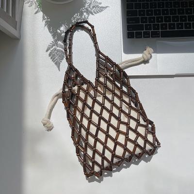 China Korean summer edition female new trend beaded handbag small number of fashion beads bag hollow-out woven hand bag for sale