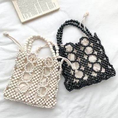 China Other 2022 summer design wholesale women beaded handbags fashion canvas beach bag ladies wooden bead casual bags for sale