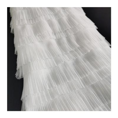 China 2022 New Factory Direct Breathable White Color Embroidery Pleated Ruffle Cake Tulle Fabric Ruffles Fabric For Dress And Apparel Making for sale