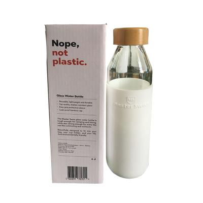 China Household Products High Borosilicated Glass Water Bottle With Lid And Silicone Sleeve Bamboo Glass Bottle Glass Cup for sale