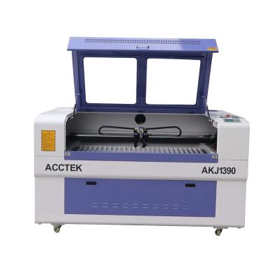 China Widely Used Water Cooled Two Heads Tissue Paper MDF CO2 Laser Engraving Cutting Machine / 6090 1390 Machines For Making Garments for sale