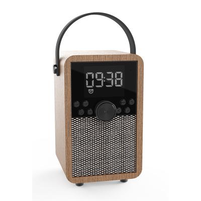 China 10W Wireless Wooden Wireless FM Radio Alarm Clock Music Phone Charger Portable Speaker for sale