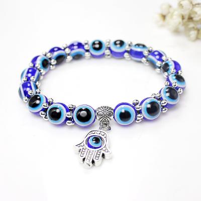 China New Fashion Turkey Environmentally Friendly Acrylic Religious Bracelet Blue Evil Eyes Bead Hamsa Hand Lucky Bracelet for sale