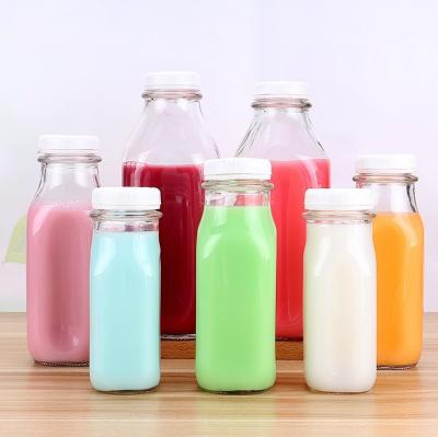 China Milk Clear Glass Milk Bottles Various Size With White Metal Cover for sale