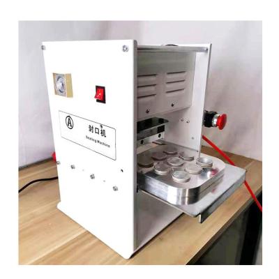 China Semi Automatic 6 Cavities Small Food Spare Aluminum Foil Coffee Capsule Heat Sealing Machine For Coffee Capsule for sale