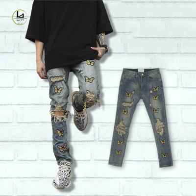 China Breathable High Street Design Style Denim Pants OEM Customized Brand Mens Stretch Slim Jeans Ripped Butterfly Embroider Jeans For Man for sale