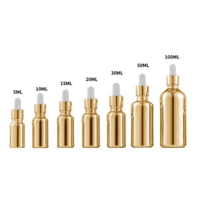 China Cosmetic UV Gold Cap Essential Oil Bottle 10ml Plating Serum Glass Bottle Essence Dropper Glass Spiral Bottle for sale