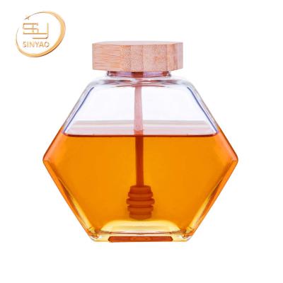 China Sustainable Mouth Food Grade Custom Wide Hexagonal Honey Glass Jar With Wooden Lid for sale