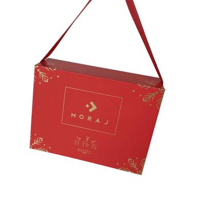 China Recycled Packaging Materials Hard Cardboard Luxury Merry Logo Materials Christmas Custom Paper Box With Magnetic Lid And Ribbon Handles for sale