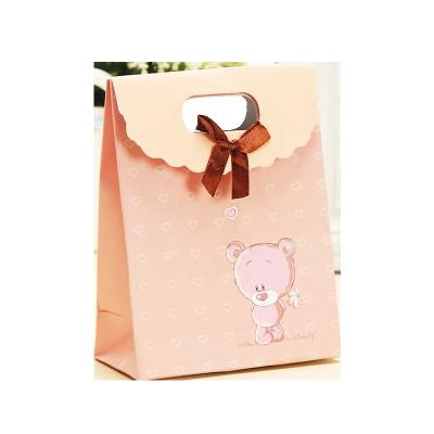 China Recycled Materials New Arrival Christmas Gift Bag Fold Backing Custom Logo Printing Ivory Board Jewelry Gift Packaging Bag With Ribbon for sale