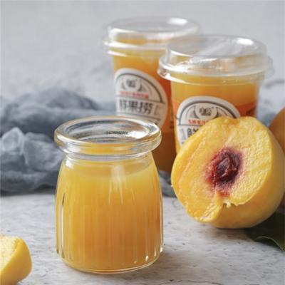 China Canned Canned Yellow Peach Carved In Fermanted Mango Juice In Plastic Cup for sale