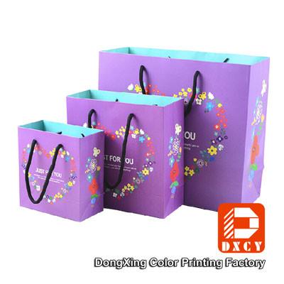 China Purple Paper Gift Bags 250 Grams Ivory Board Paper Shopping Bags With Nylon Strings for sale