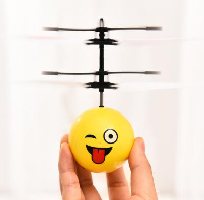 China Hot Sale Induction Toys Plastic Flight Ball With Expression Face Design Light Sensor Flight Ball for sale