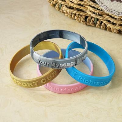 China Custom printed silicone wristbands with embossed text for sale