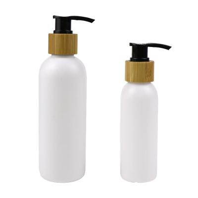 China Personal care 60ml 100ml 160ml 200ml shampoo cosmetic pe lotion plastic pump bottle with bamboo lid for sale