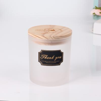 China Hot Sale Empty Sprayed Colored Glass Candle Jars Daily Life Home Candle Glass Container With Wooden Lids for sale