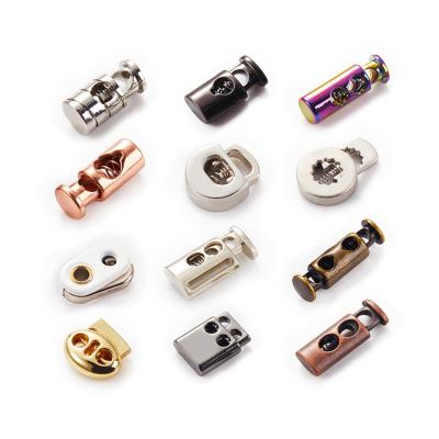 China Custom Zinc Alloy Engraved Stopper Nickel Free Bell Stopper Metal Cord Rope End Spring Lock Stopper for sale