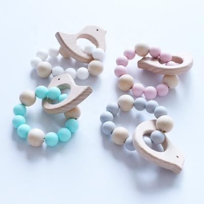 China 100% Eco-friendly Baby Teething Bracelet Silicone And Wooden Beads Baby Teething Ring Toy for sale