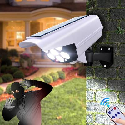 China Outdoor Security Solar Light Dummy Camera Garden Motion Sensor Wireless Outdoor Flood IP65 Waterproof 77 LED Lamp 3 Mode For Garden for sale