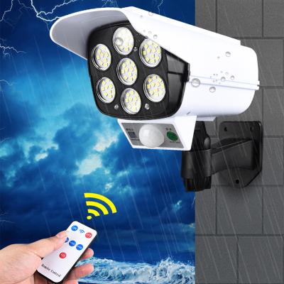 China IP65 Security Solar Light Dummy Camera Wireless Outdoor LED Motion Sensor Flood Light Lamp 3 Mode For Garden for sale