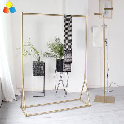 China Floor Gold Closing Shop Store Display Design Stand Swept Retail Clothing Racking for sale