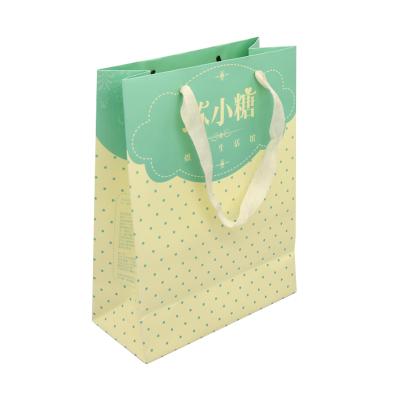 China New Recyclable Colored Silk Logo Hot Foiled Stamping Matt Kraft Paper Bag With Handles for sale