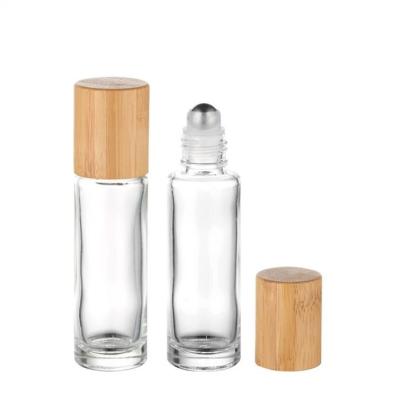 China 10ml Recycled Material Transparent Refillable Glass Essential Oil Roll On Bottle With Steel Roller Ball And Bamboo Lid for sale